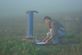 Gabriel Rau dipping a borehole